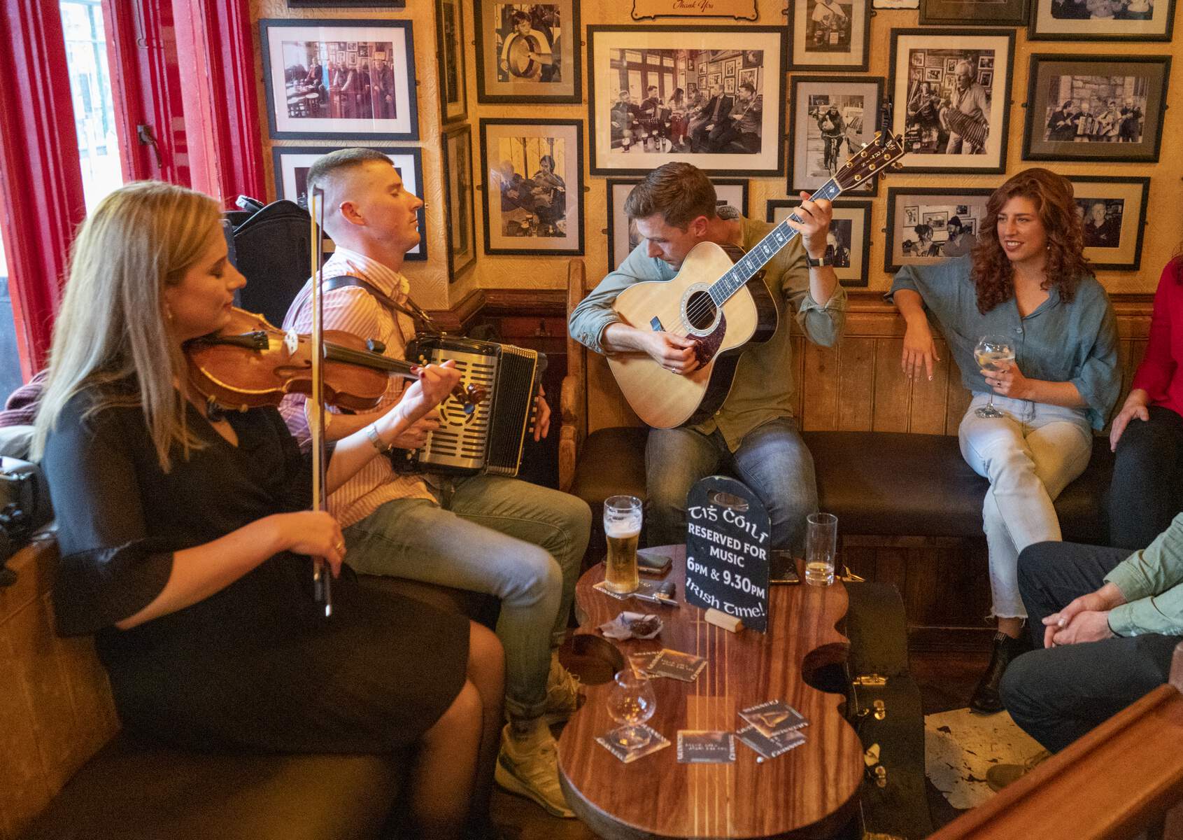 Traditional Irish music session in a pub in Galway showing musicians playing traditional instruments